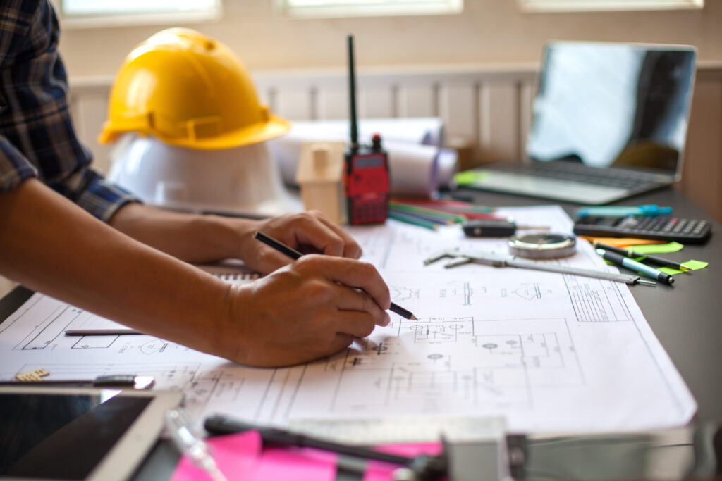 Concept Architect and desk of Architectural project in construction site or office building with mining light